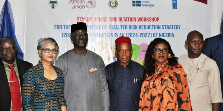 DG NEMA, Mustapha Habib Ahmed (middle) flanked by participants at the Disaster Risk Reduction Strategy workshop in November
